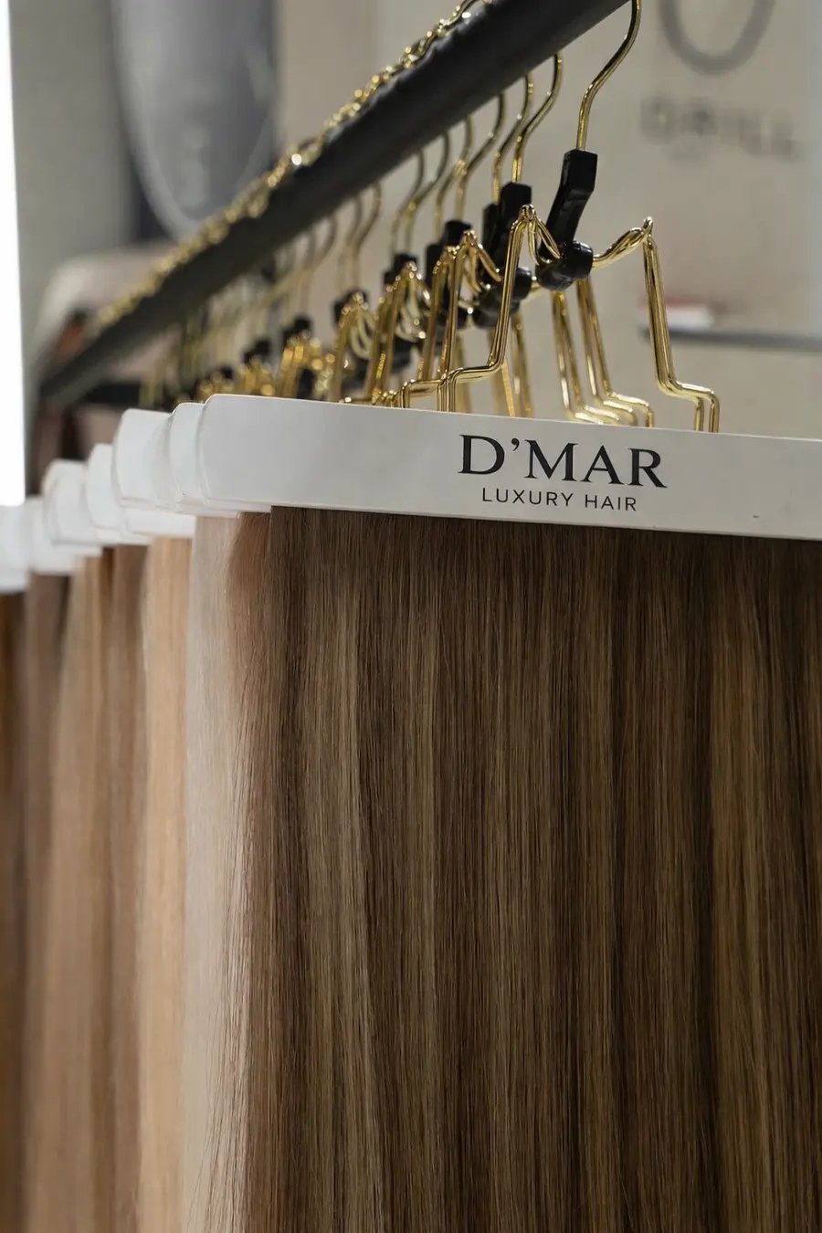 The gold D'Mar Luxury Hair extension rail at the salon